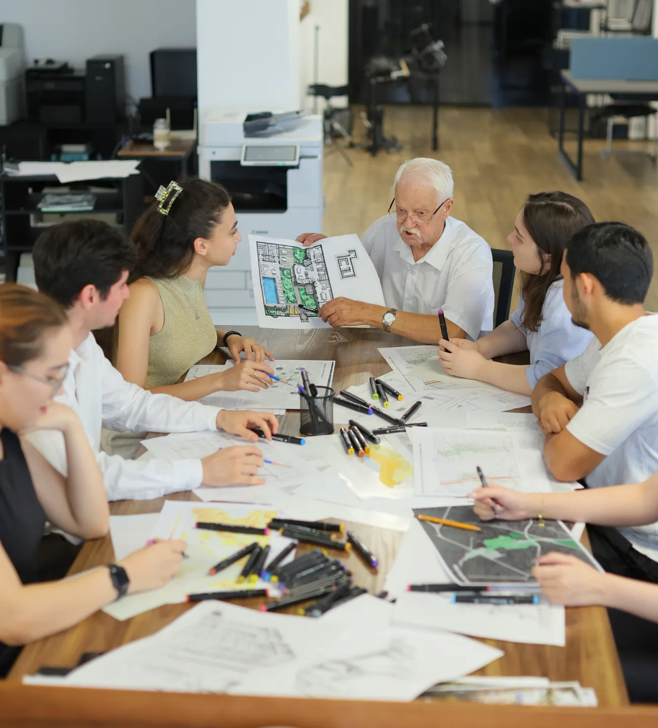 Alexander Kuranov, chief architect of SAD, reviewing drawings with students and interns