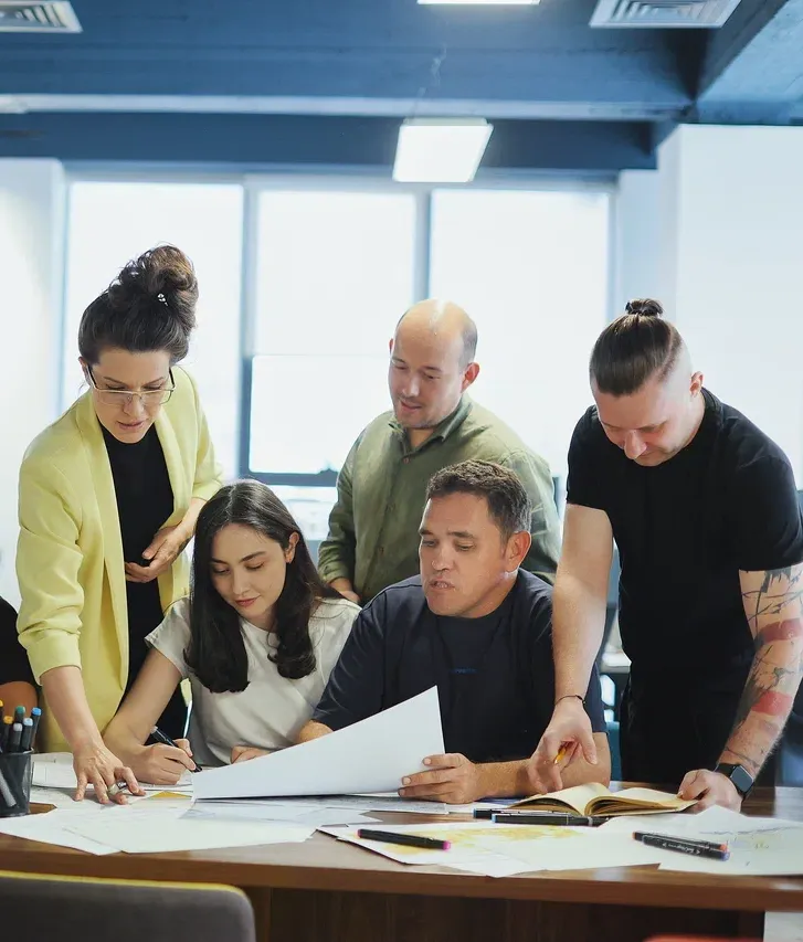 Architects, engineers and urbanists of SAD working on a project at a shared table