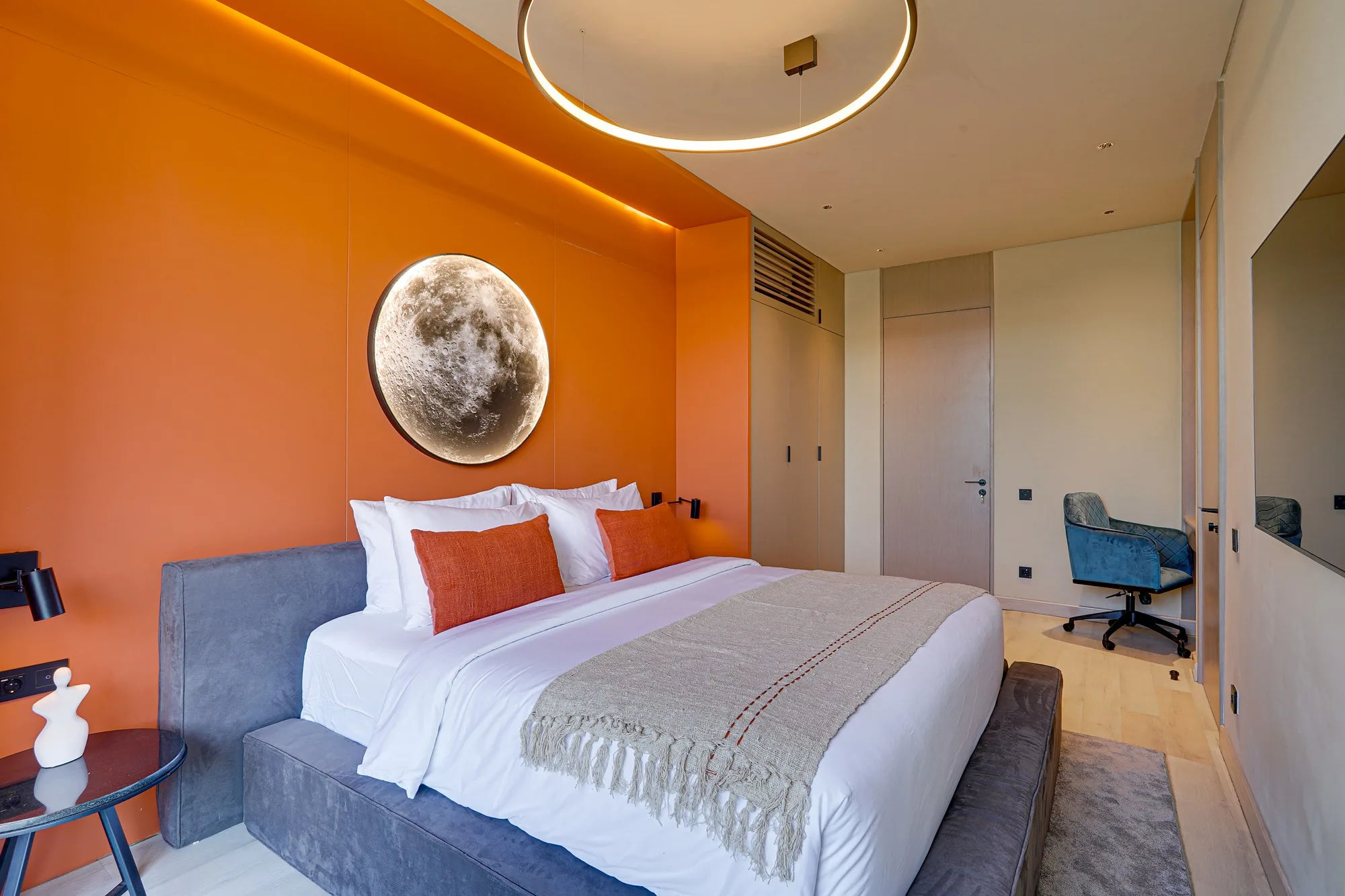 The villa bedroom with an orange wall and a round light