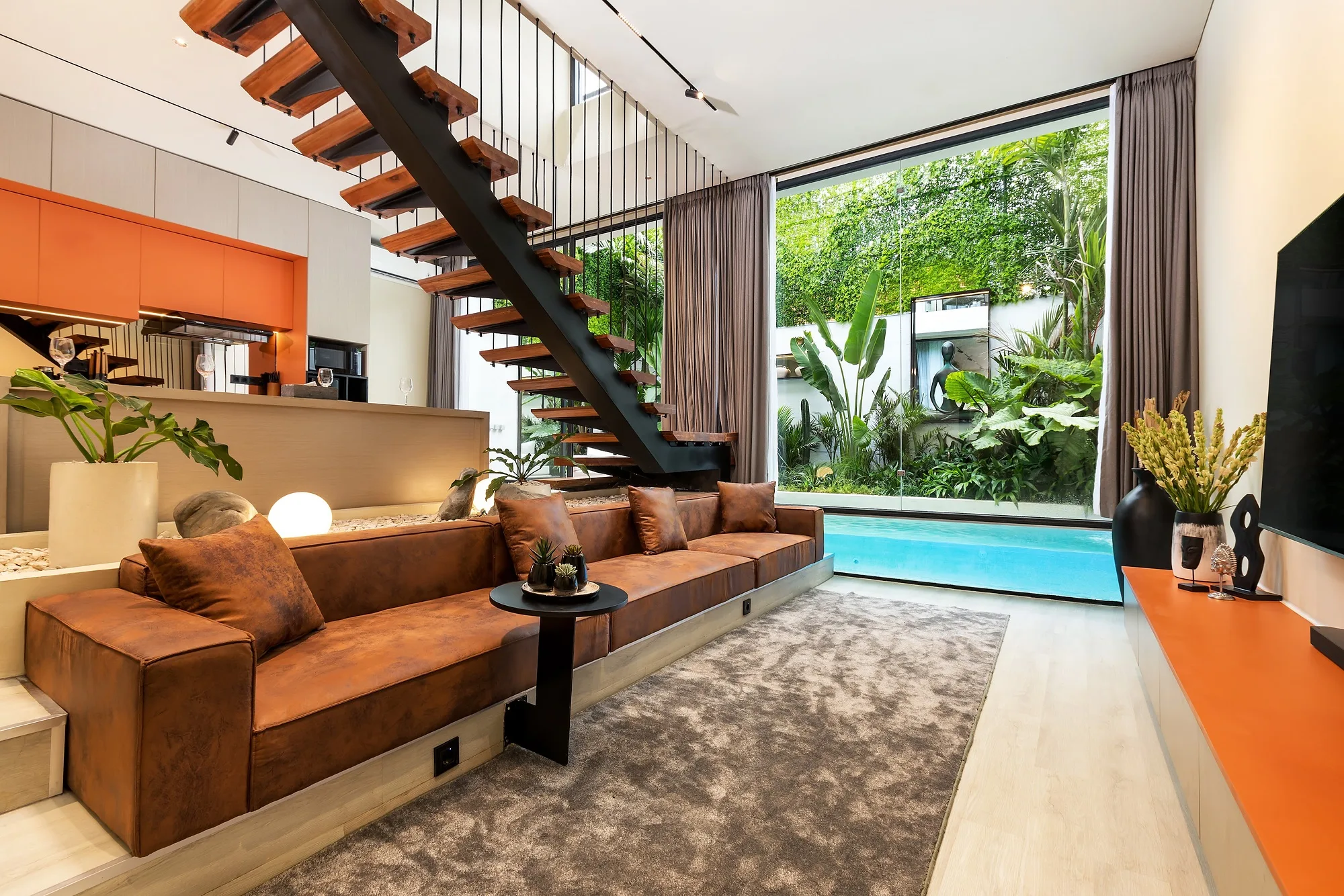 The living area under the stair: seating and the opening to the glazed courtyard
