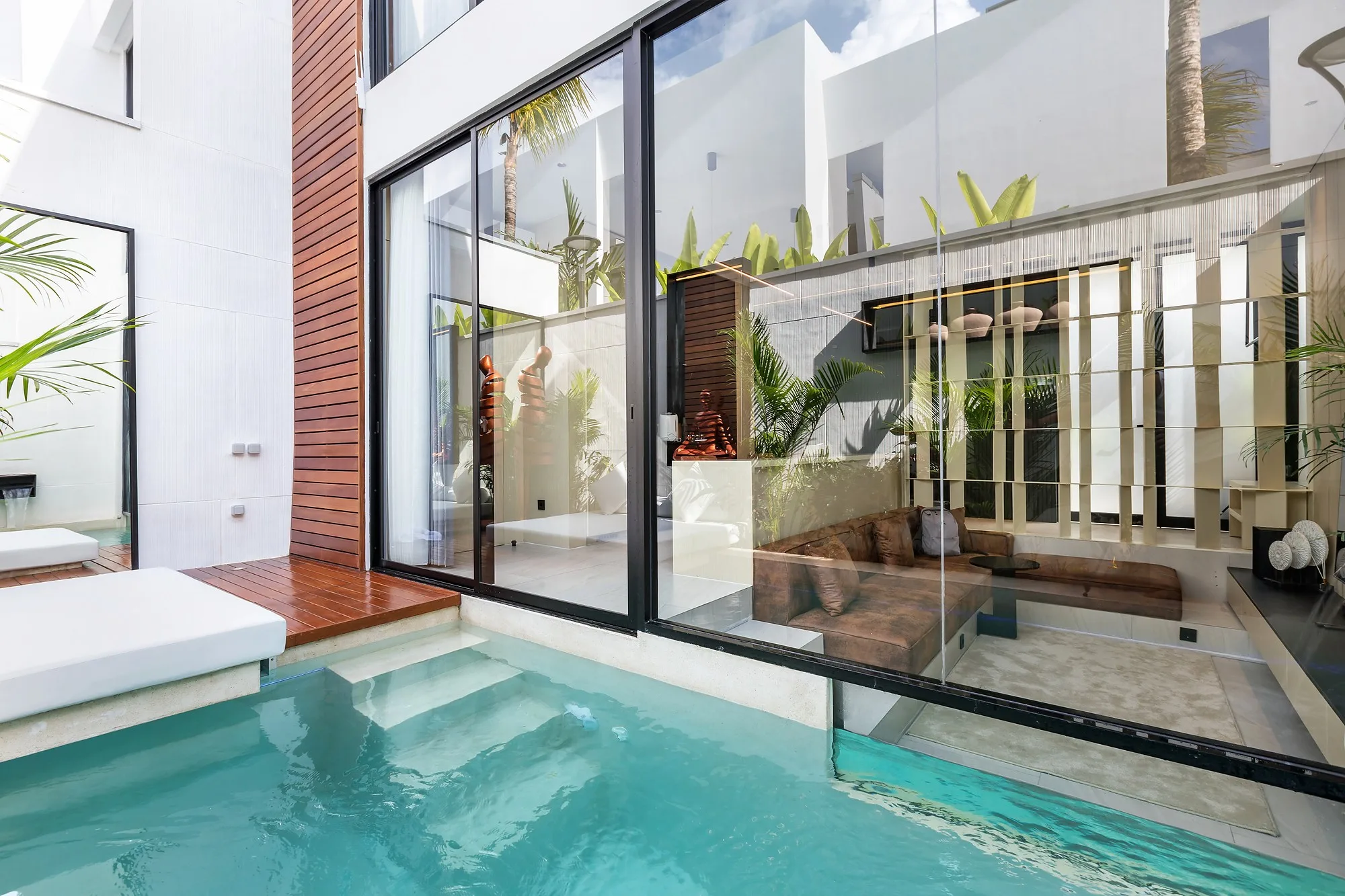 The courtyard pool and the sliding glazing of the living room