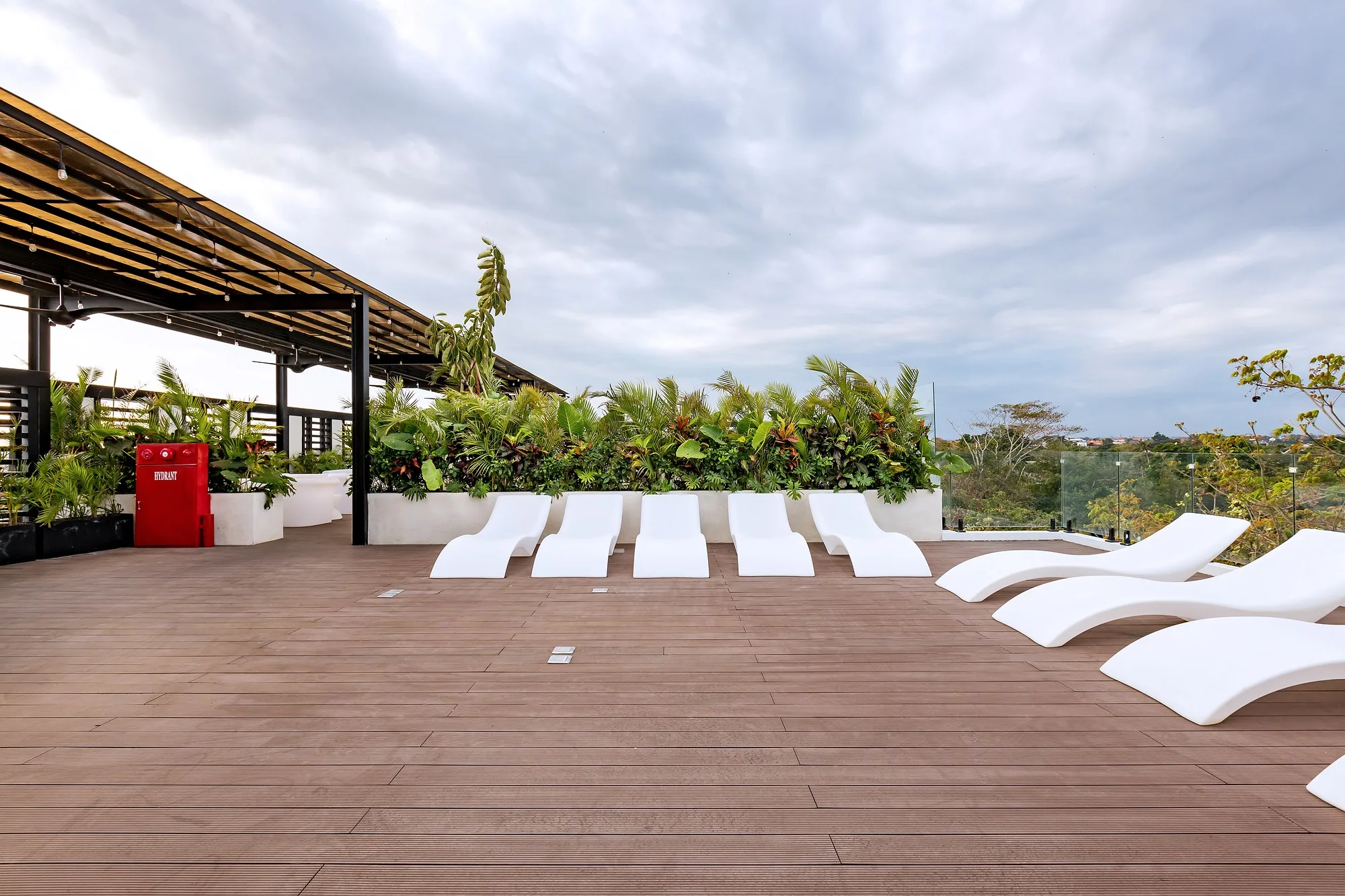 The roof of Alex Villas 5: decking, loungers and a planted canopy
