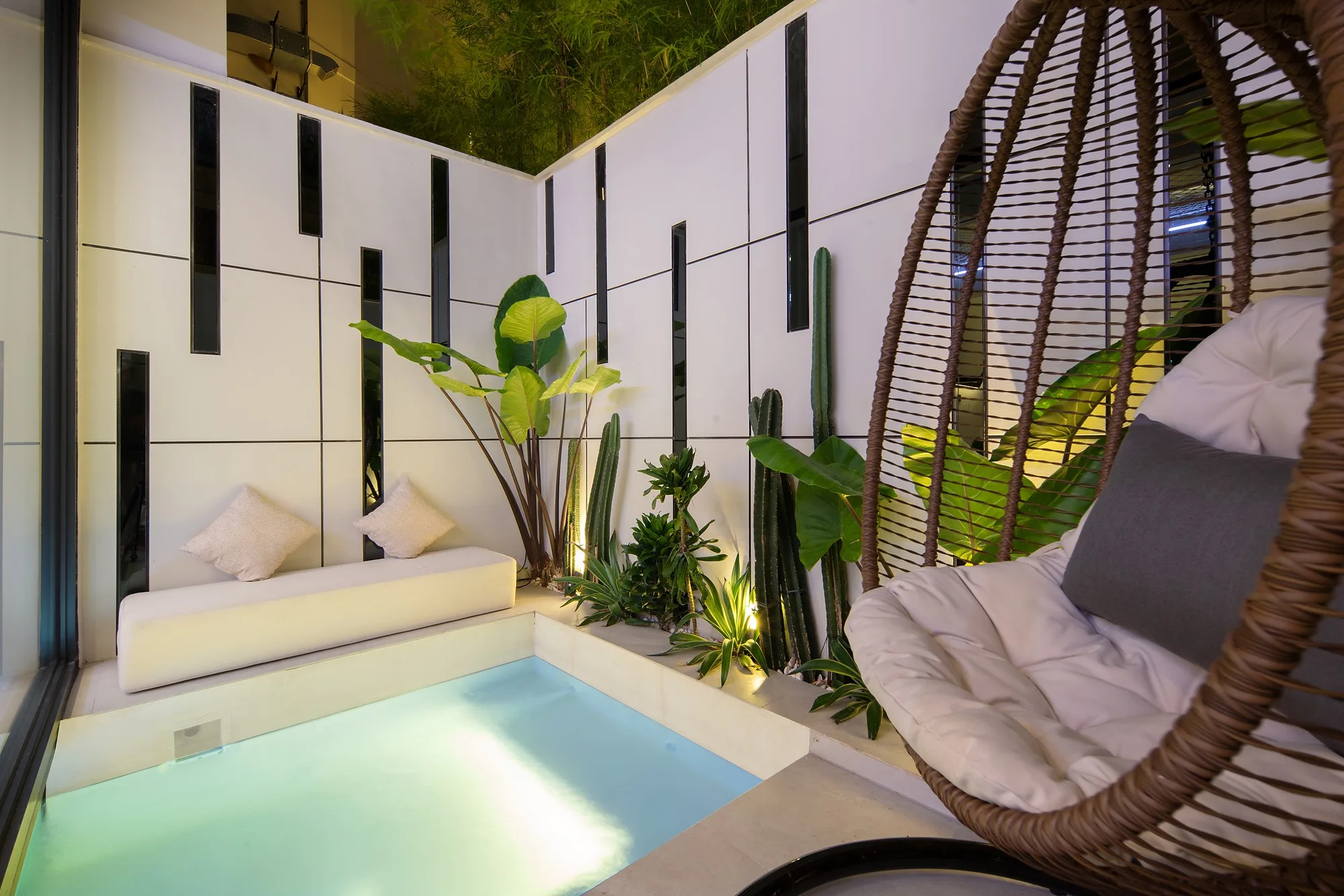 The pool at Alex Villas 6 with a hanging chair and tropical planting