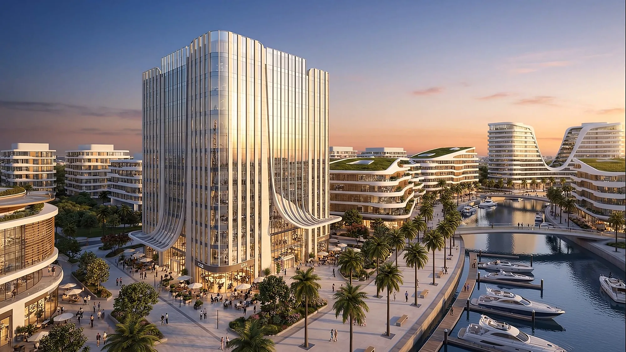 A waterfront public complex at sunset: a palm-lined embankment and a marina