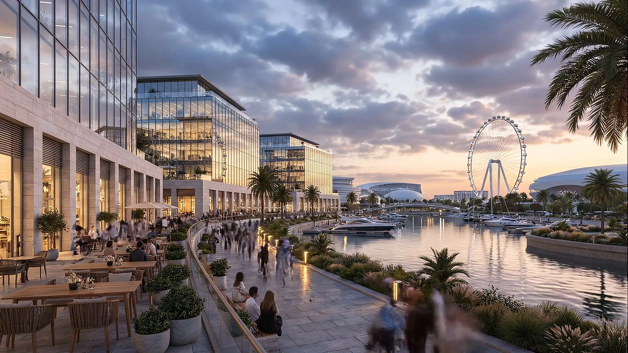 The waterfront with cafés and palms, looking across the bay at dusk