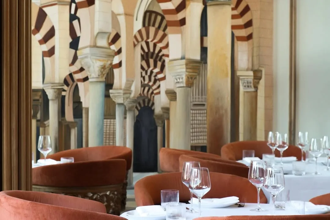 Photo of laid tables by the arched wall