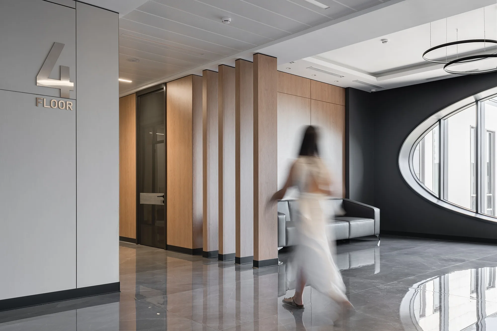 Fourth-floor lift lobby with fluted partitions, SAD architecture studio
