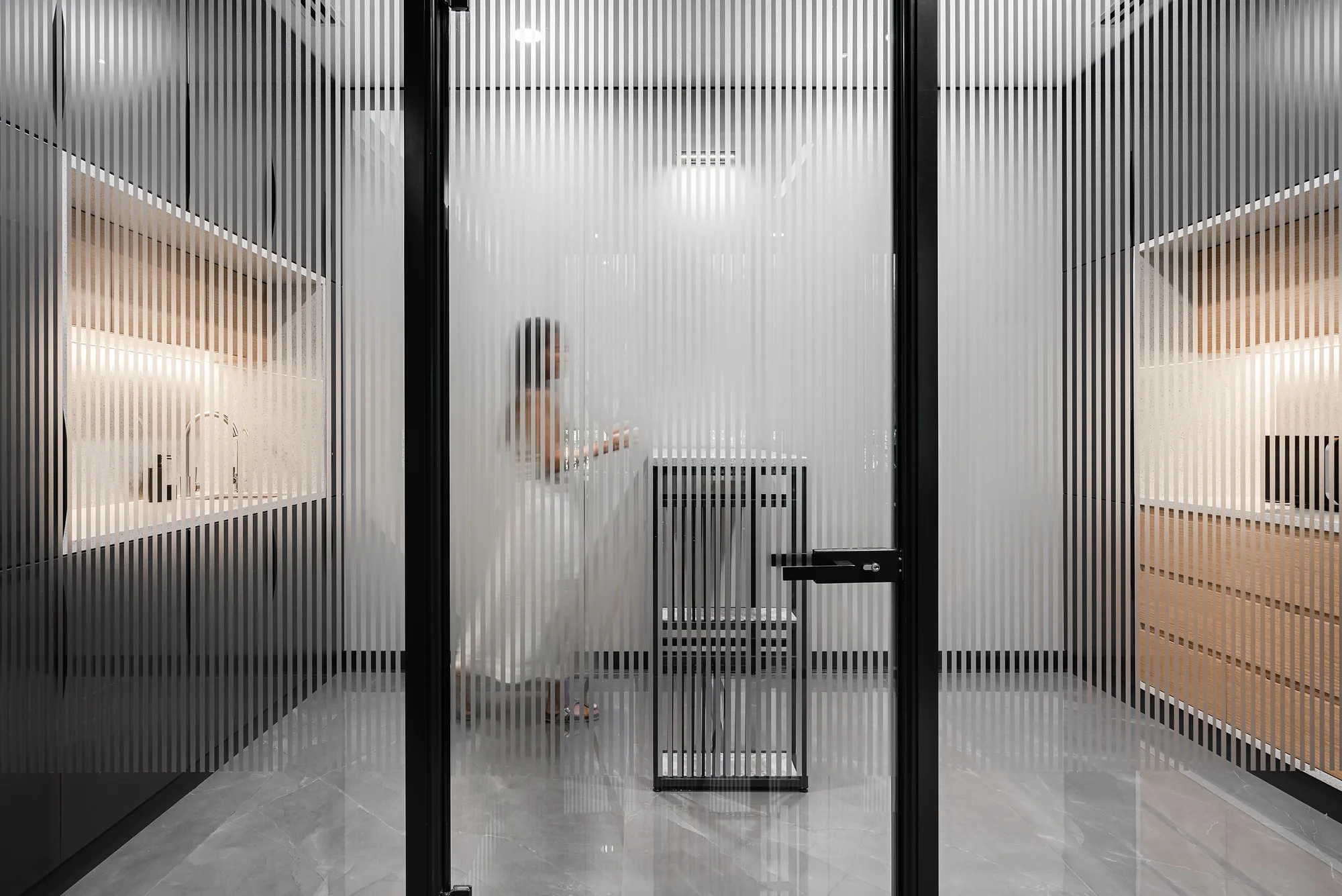Corridor with fluted glass partitions between work areas, SAD architecture studio