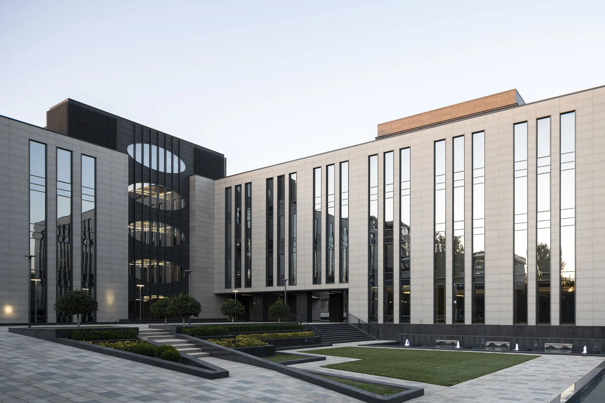 Courtyard facade of the business centre: a rhythm of vertical windows over a dark plinth
