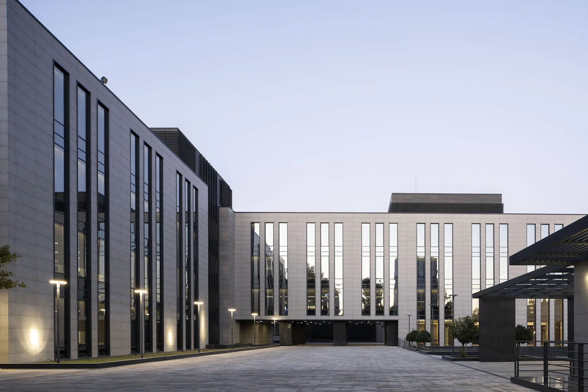 Business centre facade with vertical windows and a canopy over the entrance