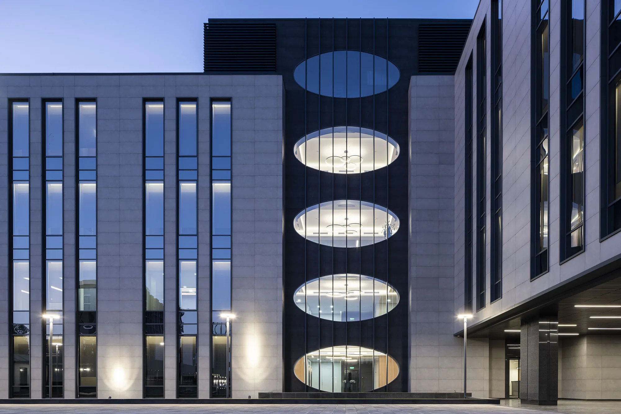 The dark volume with oval windows under evening lighting