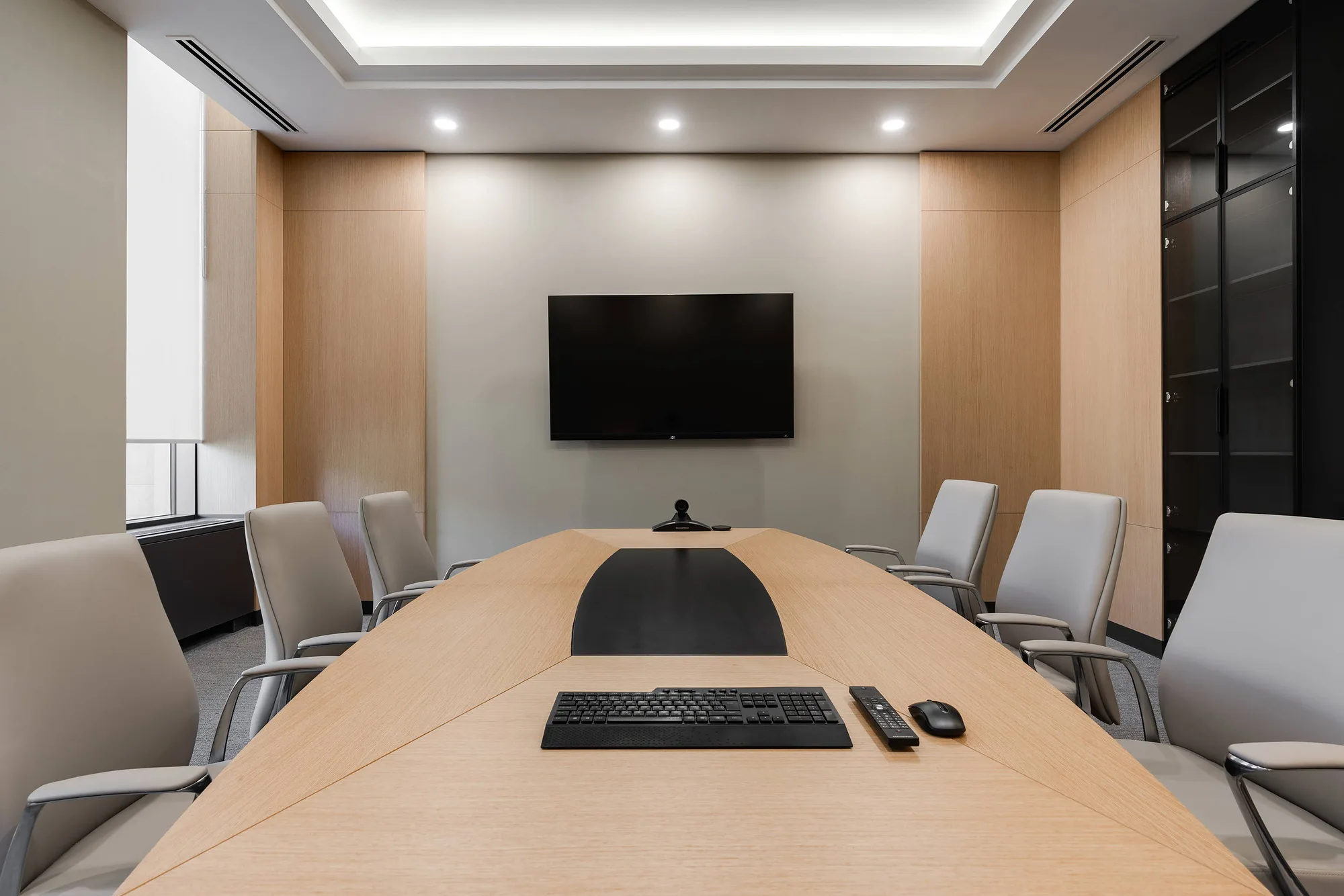 Meeting room of the business centre: an oval table and a screen for video calls