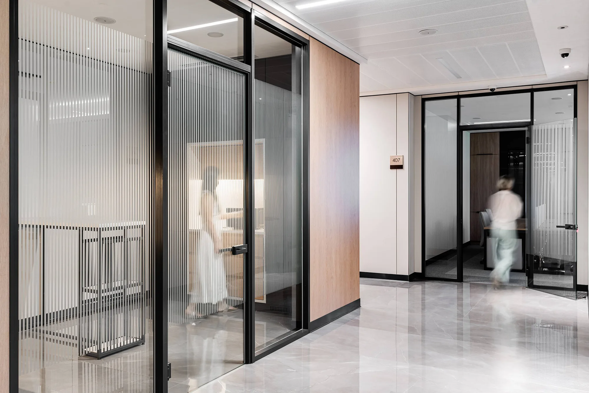 Office floor corridor with glass partitions and fluted glass