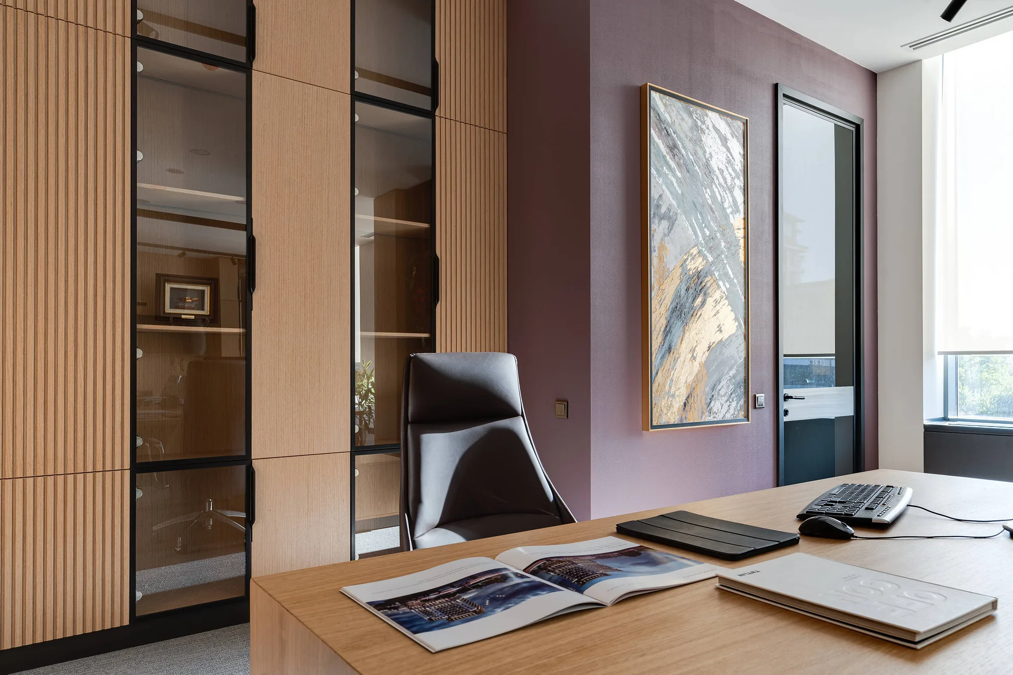 Private office with timber panelling and a painting on the wall