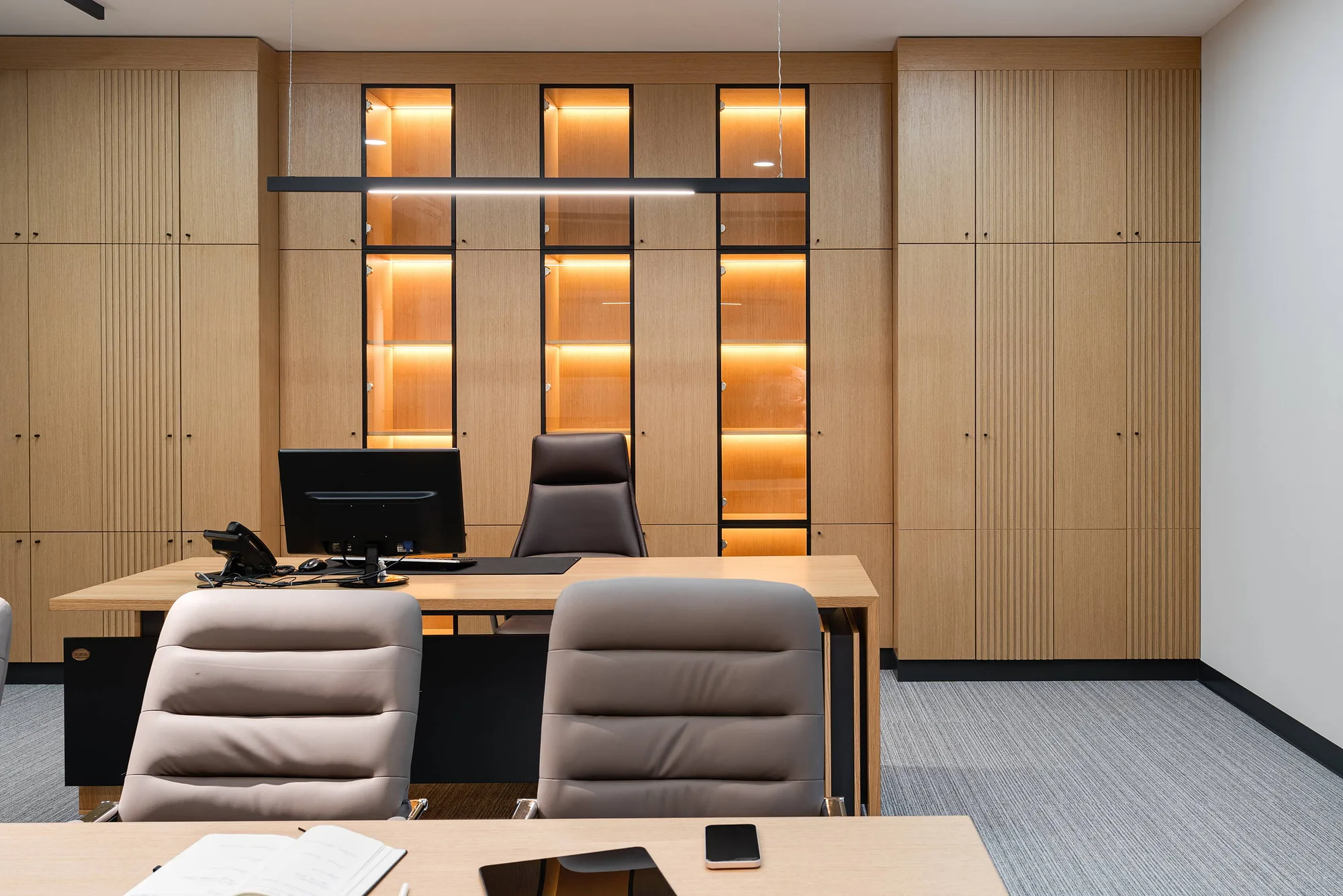 Executive office: a desk and lit niches set into the panelling
