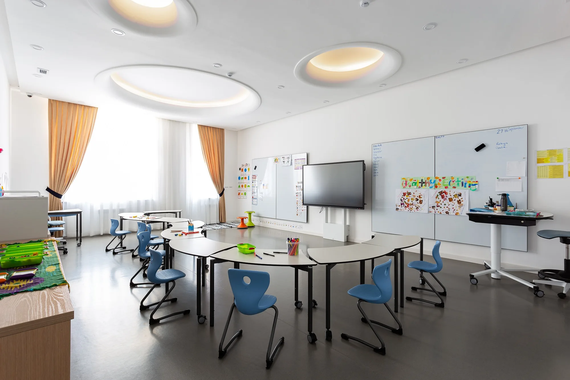 A classroom with work tables and the window zone