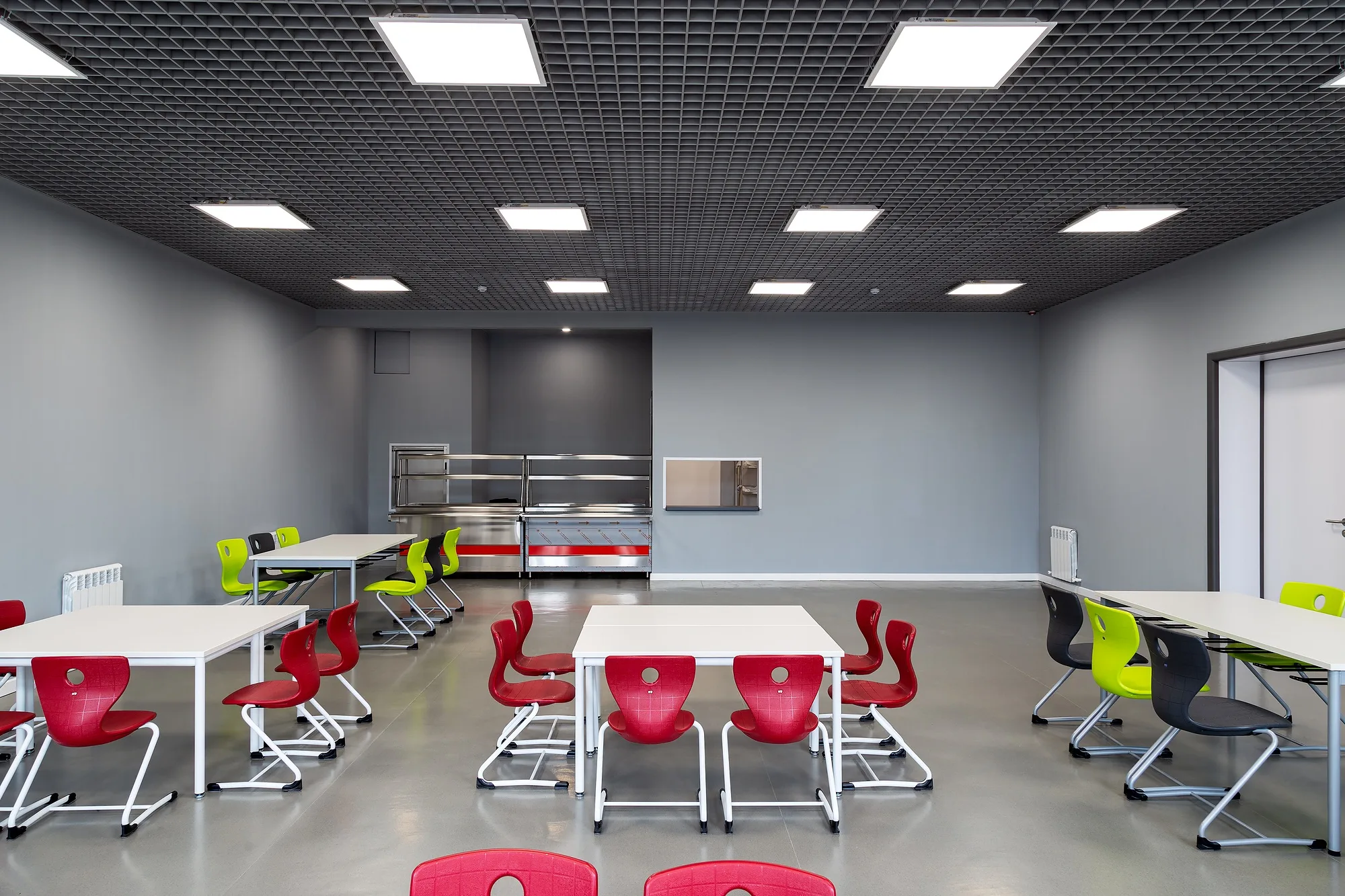 A classroom with coloured chairs and the board