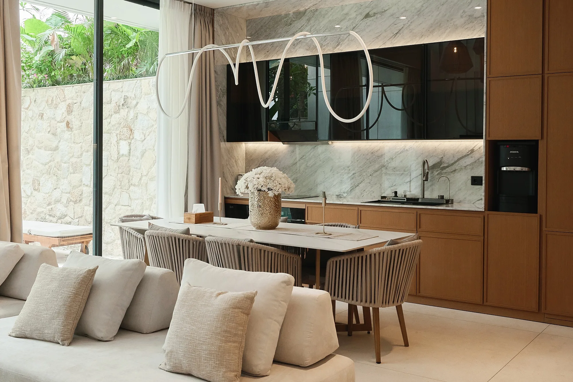 The dining area by the full-height glazing opening to the courtyard