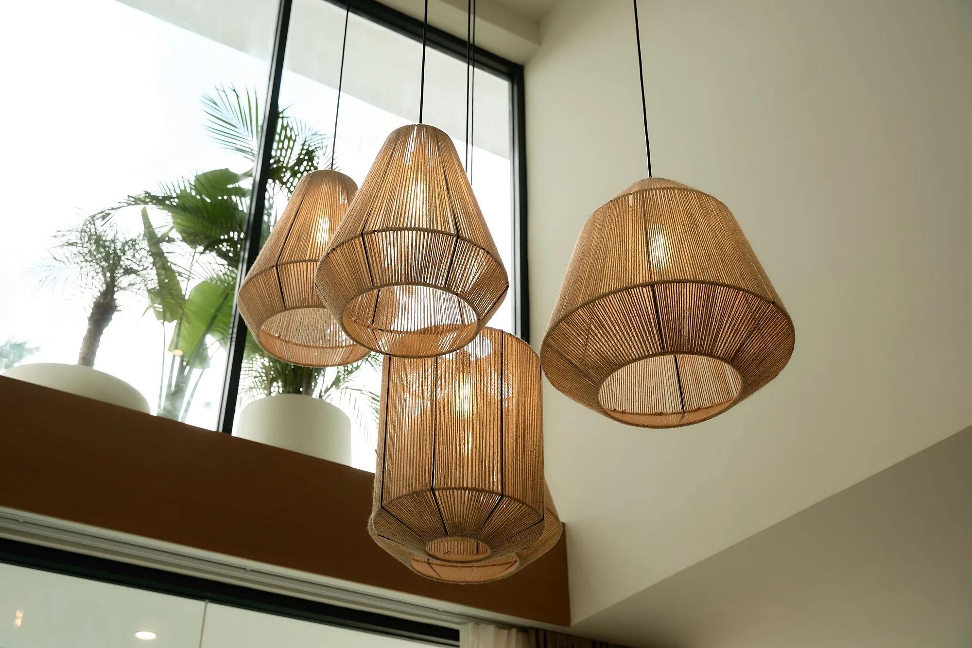 Woven pendant lights above the seating area on the villa terrace