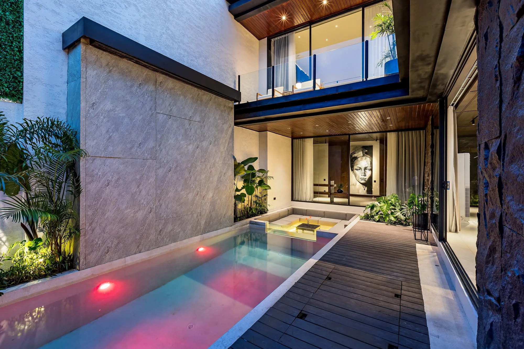 Grey Villas in Bali at dusk: the dark stone volume of the villa and the pool along the house