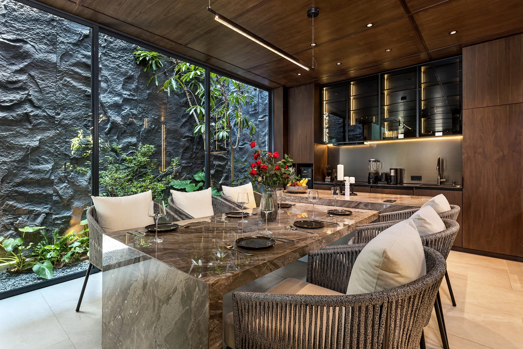 The dining area at the glazing looking onto the green courtyard wall