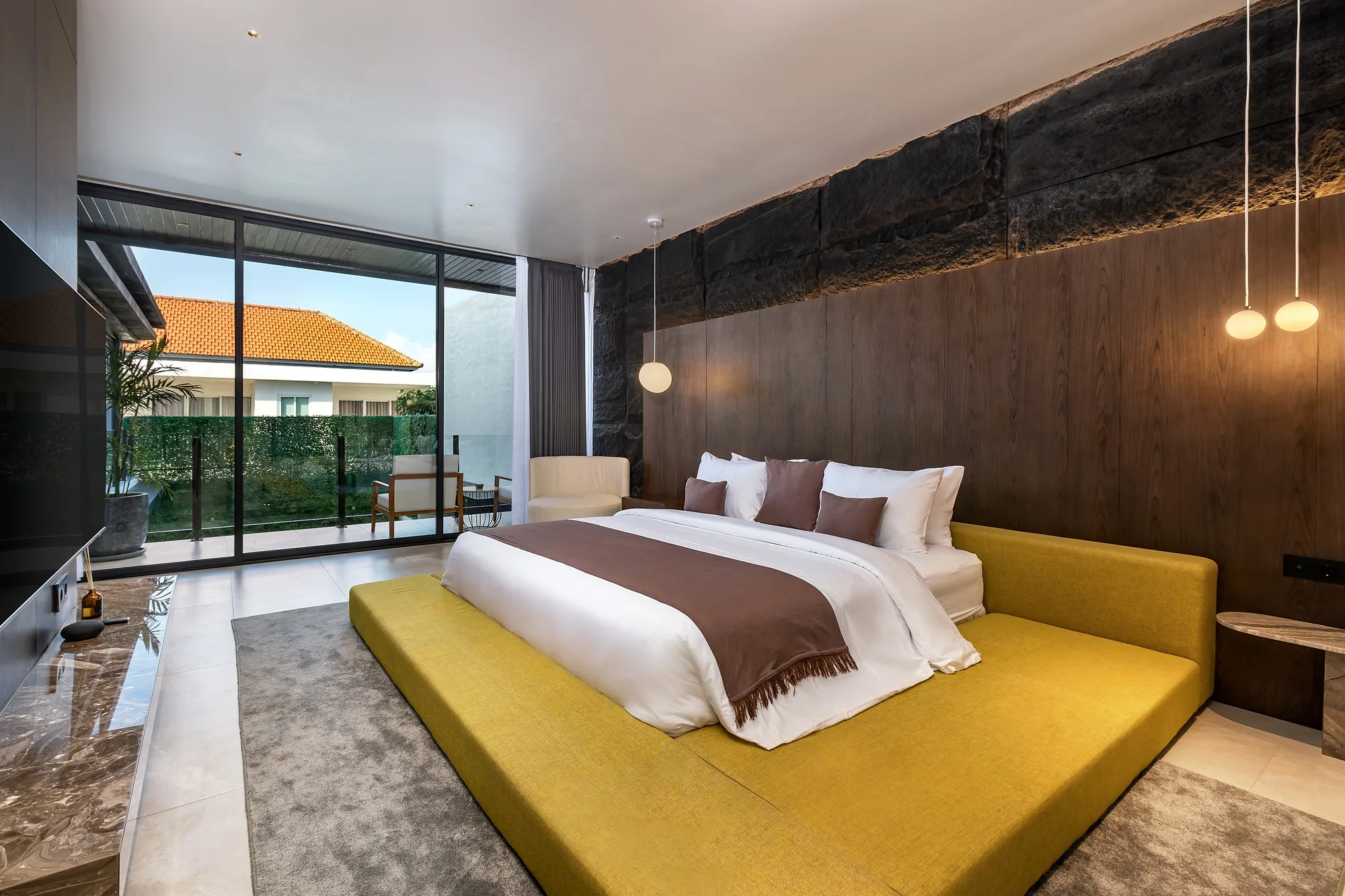 A bedroom with a yellow bed and a lit niche