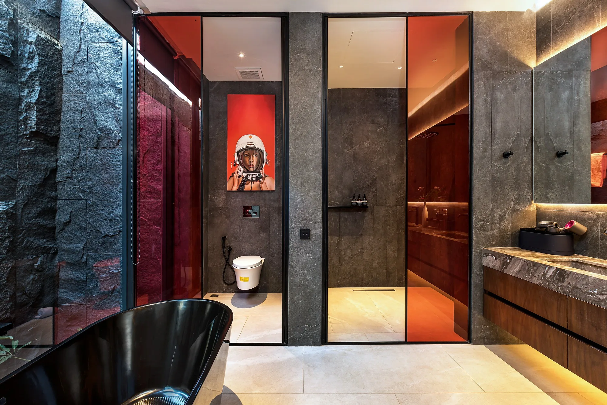 The bathroom at Grey Villas with a freestanding tub and coloured lighting