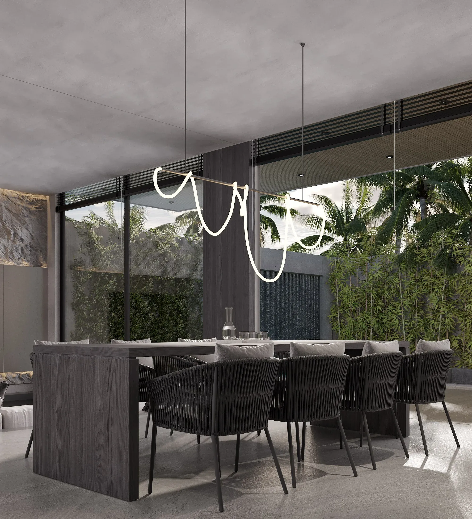 Dining room of a Jalan Tegal Cupec villa in Bali towards the garden: floor-to-ceiling glazing with palms beyond — SAD studio