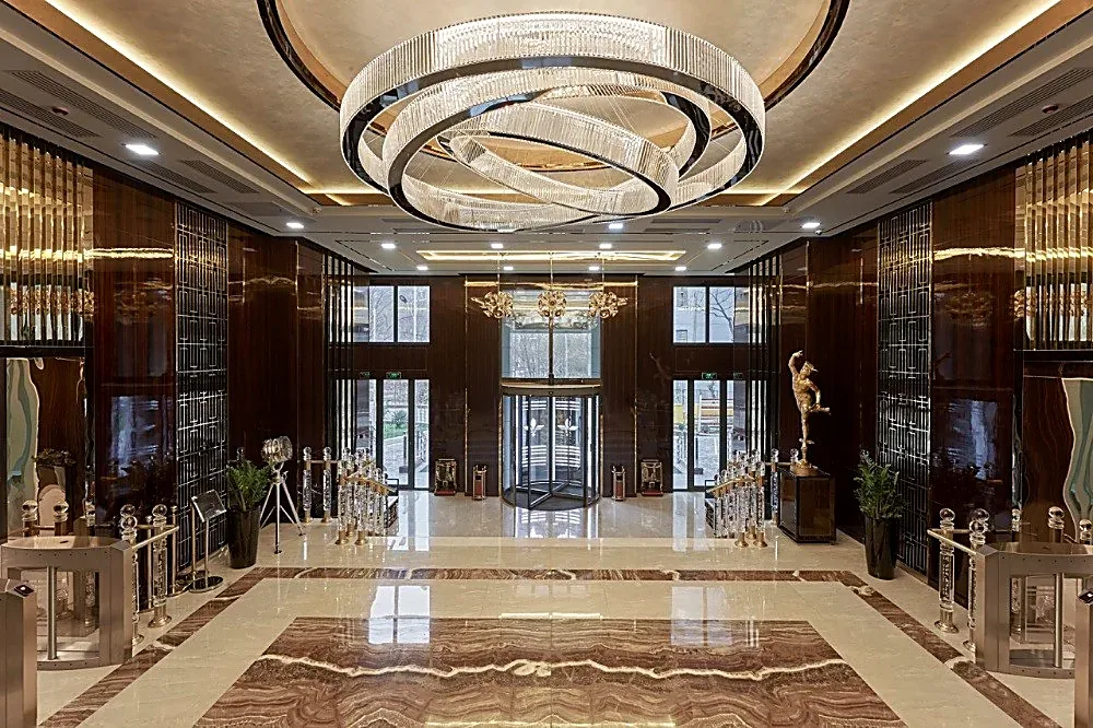 Mercury business centre in Tashkent: the main lobby with marble floor, ring chandelier and stair — SAD studio