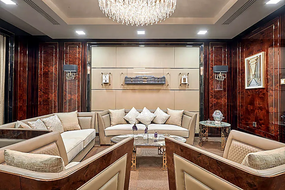 The lounge of the Mercury business centre: sofas around a low table beneath a crystal chandelier