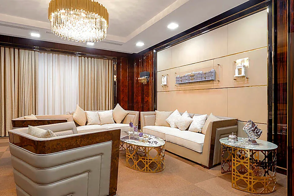 The lounge area of the Mercury business centre: corner sofas, gilded side tables and full-height curtains