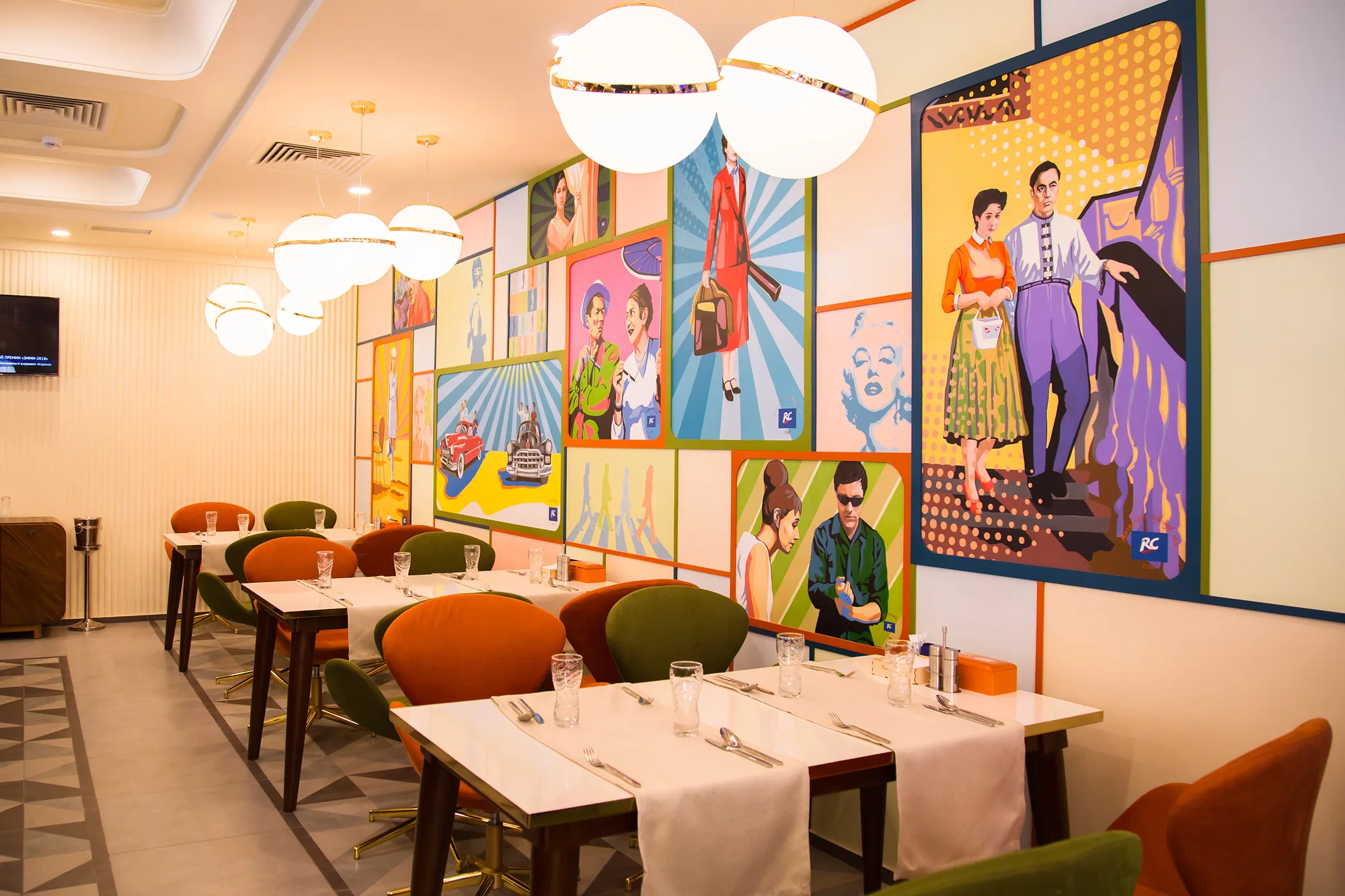 Hall of Ogni Tashkenta with pop-art panels: Soviet-style graphics and tables along the wall — SAD studio