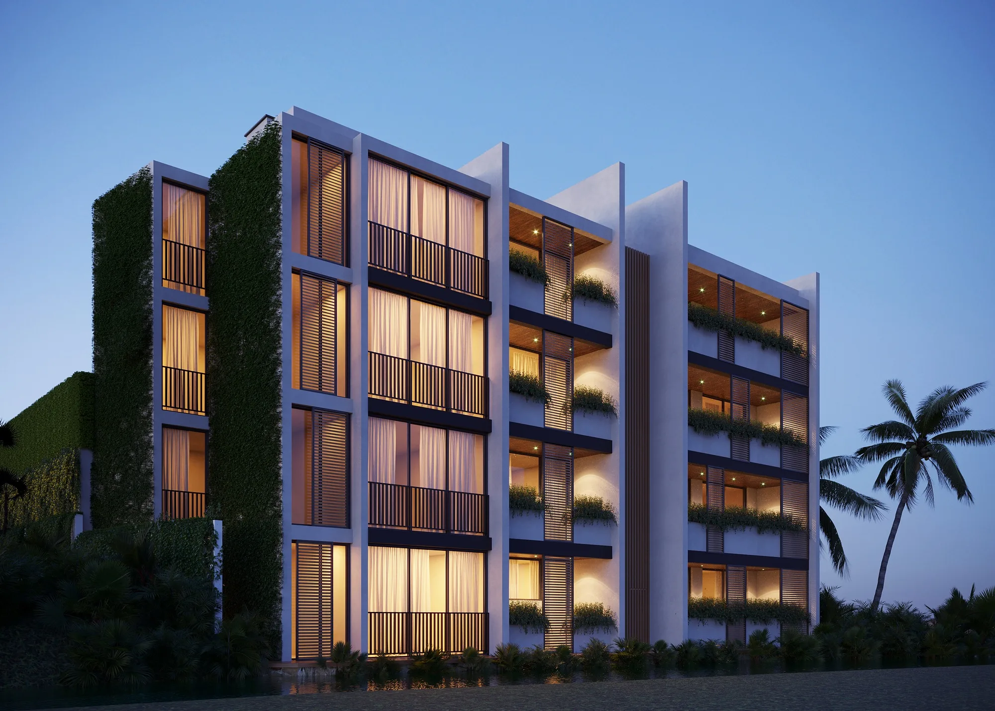 The apartment building in the evening: lit flats and the green of the balconies