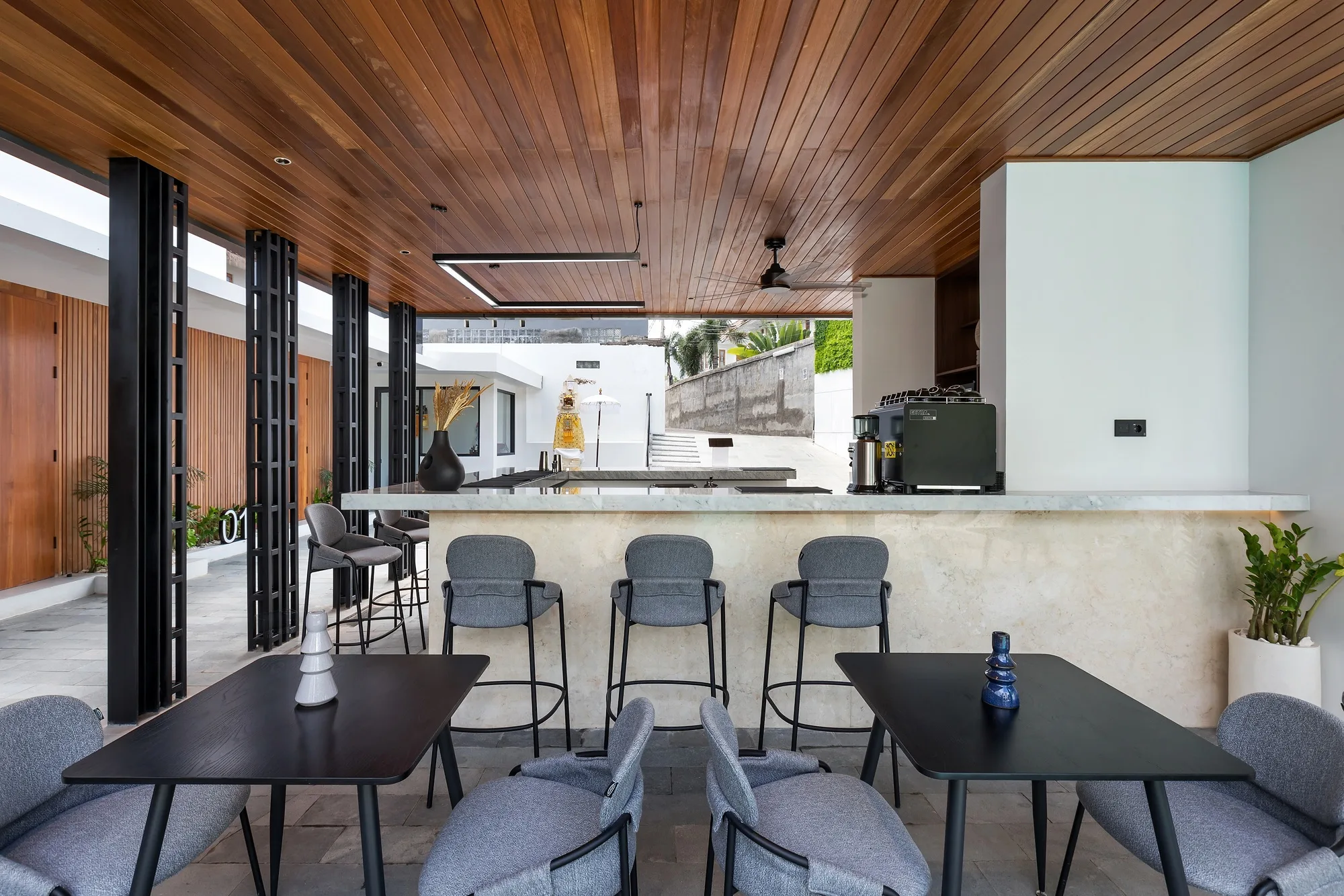 The shared kitchen and bar of the complex under a timber ceiling