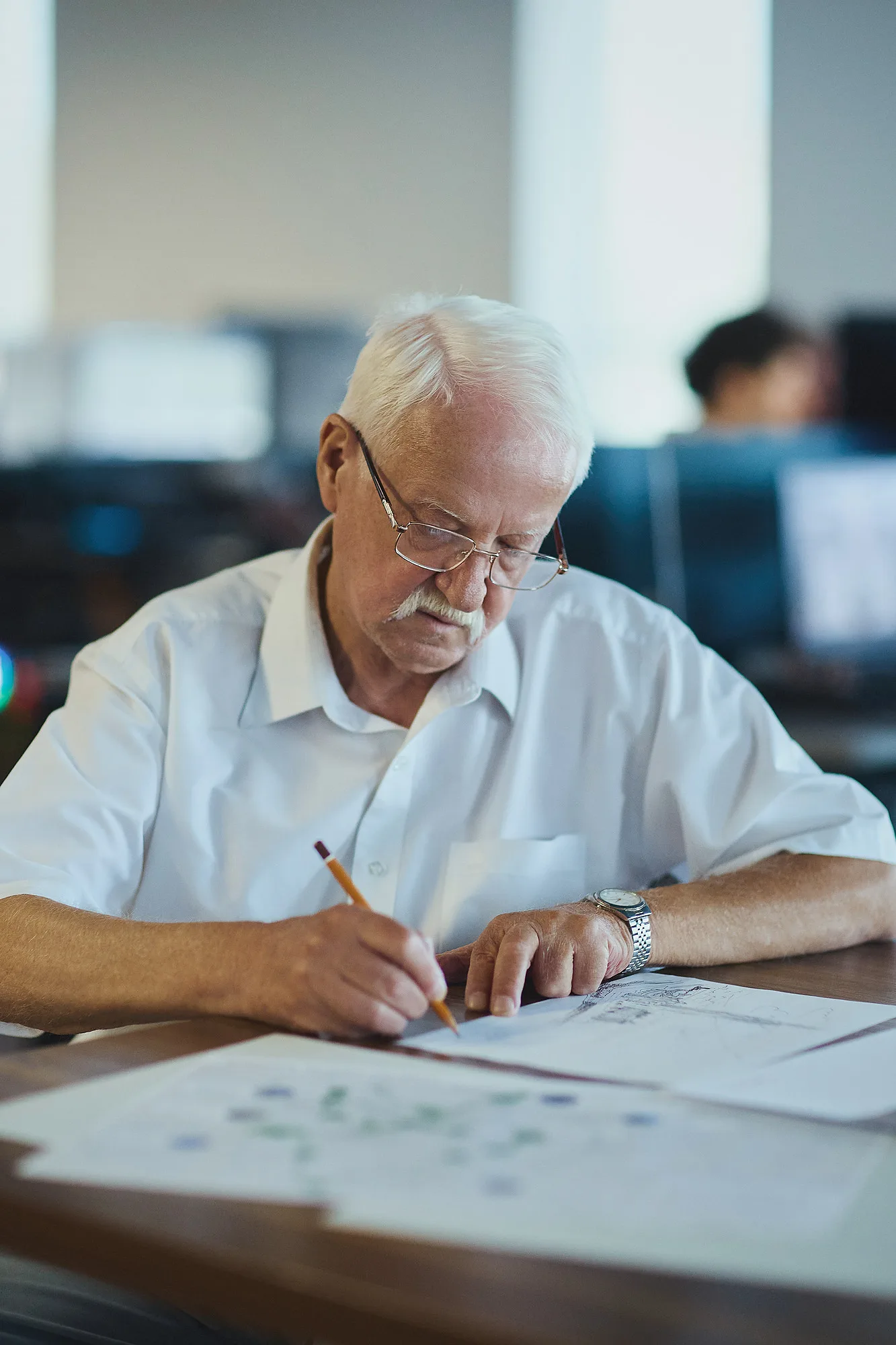 Alexander Kuranov working on a drawing at the SAD office in Tashkent