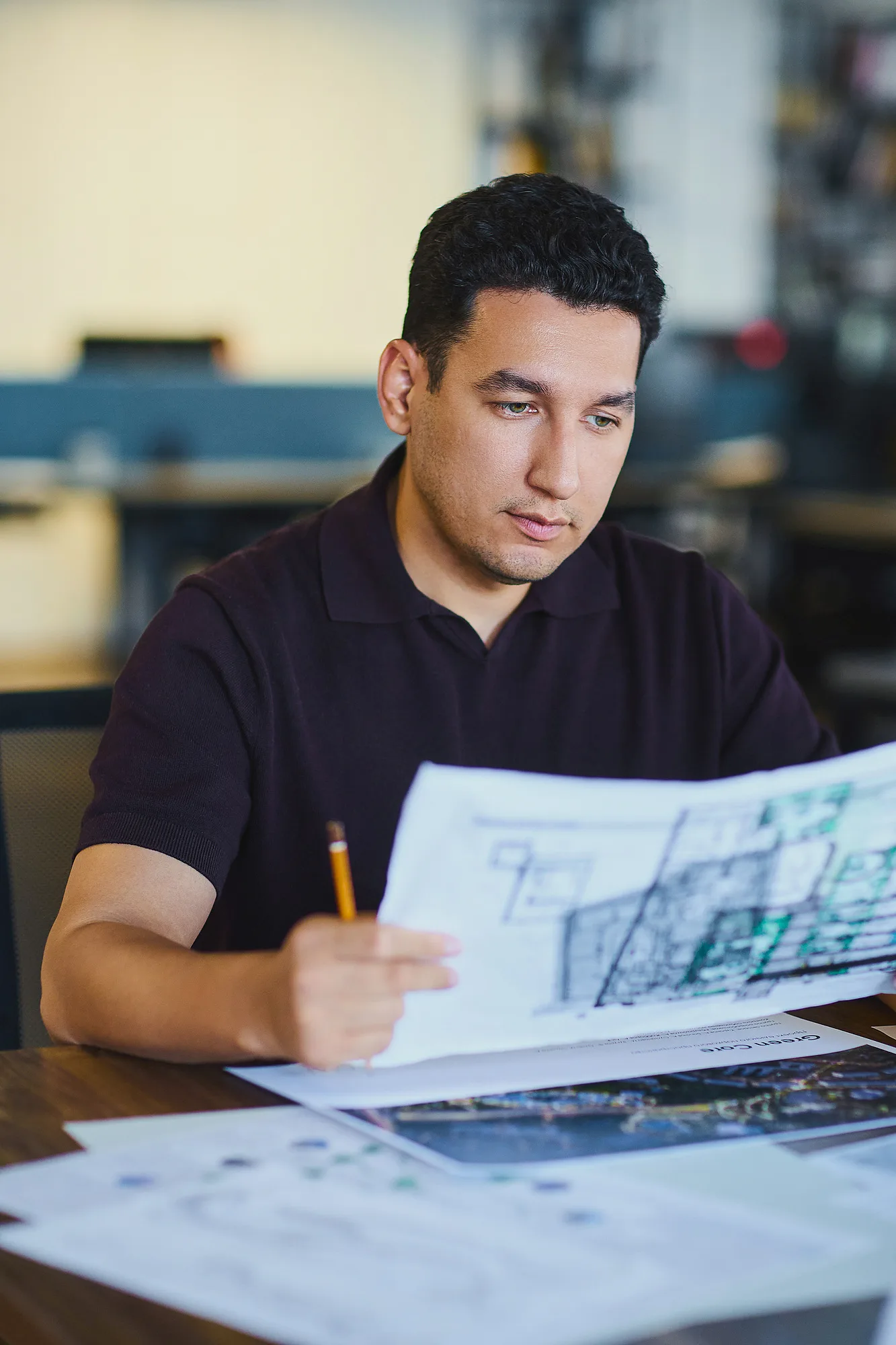 Davron Talipov, co-founder of SAD, going through working drawings at his desk