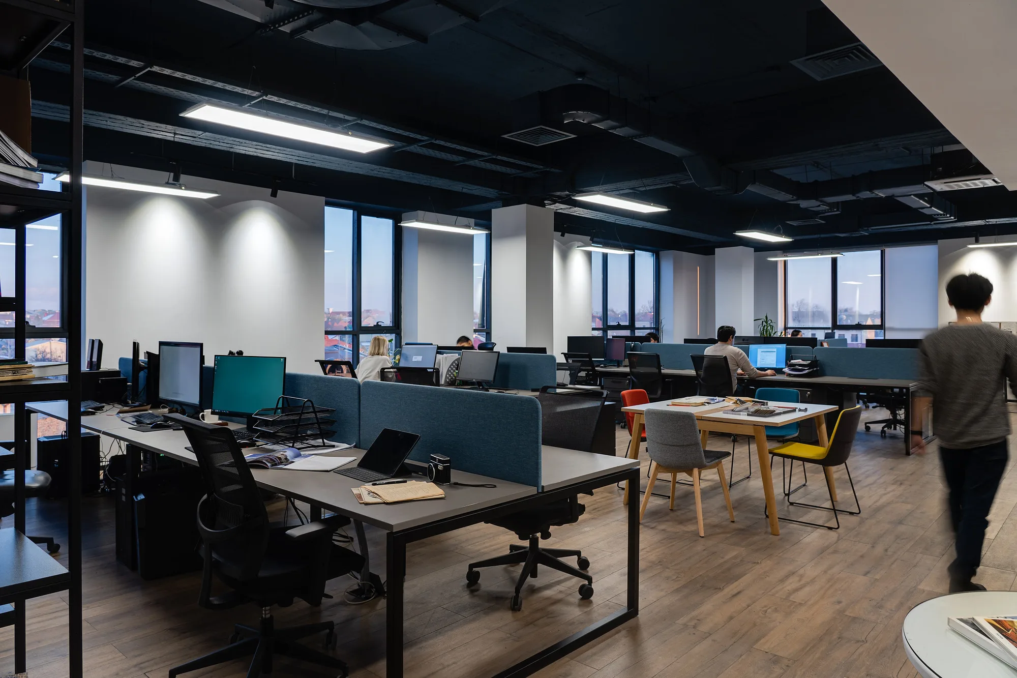 Open space of SAD studio: workplaces along the windows, a soft seating zone and staff at work — SAD studio