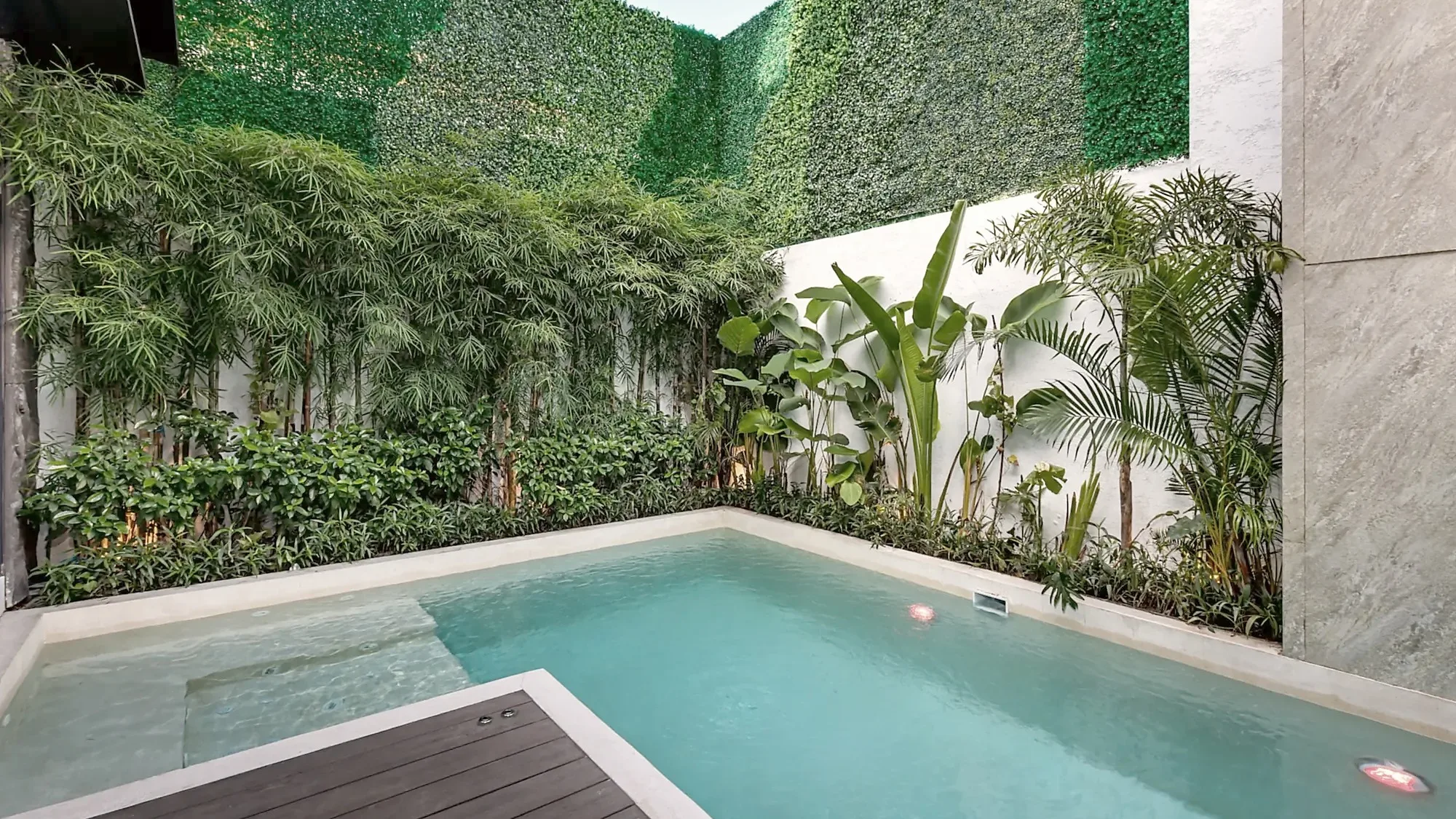 Pool and green wall of a private villa on Bali