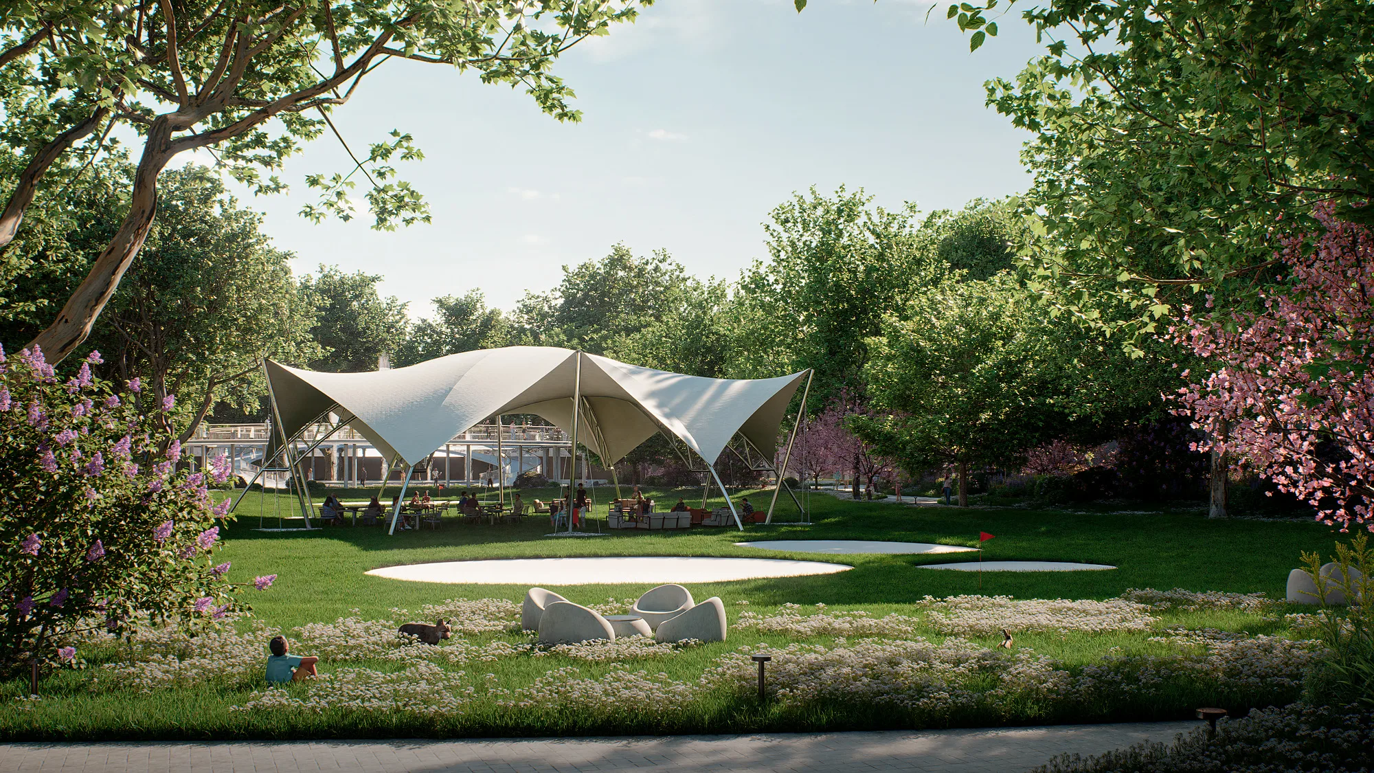 A lawn in Sheron park with a tented pavilion and open grass