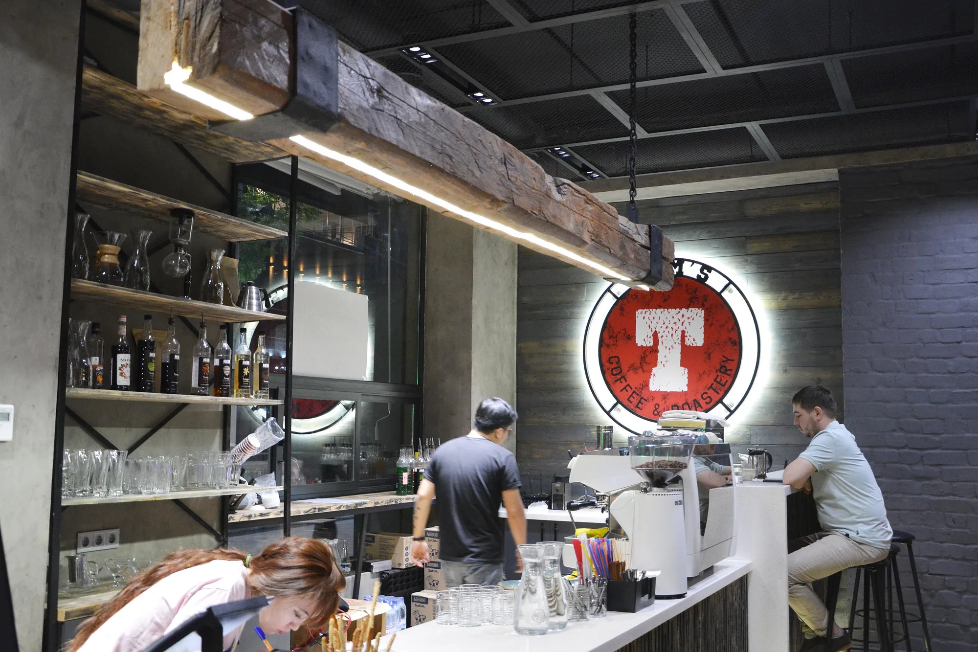 TIM'S Coffee & Roastery in Tashkent: the bar with open shelving and the logo — SAD studio