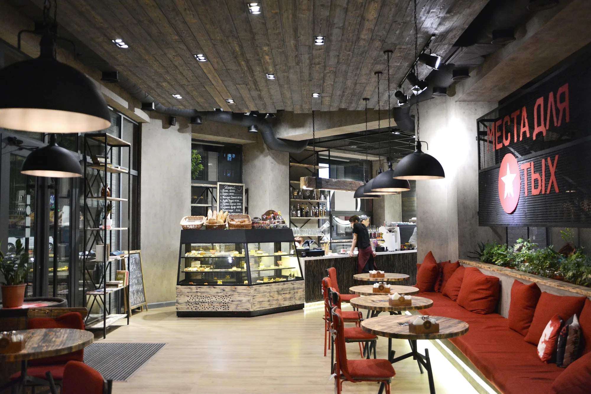 TIM'S Coffee & Roastery in Tashkent: the hall with the display counter and banquettes — SAD studio