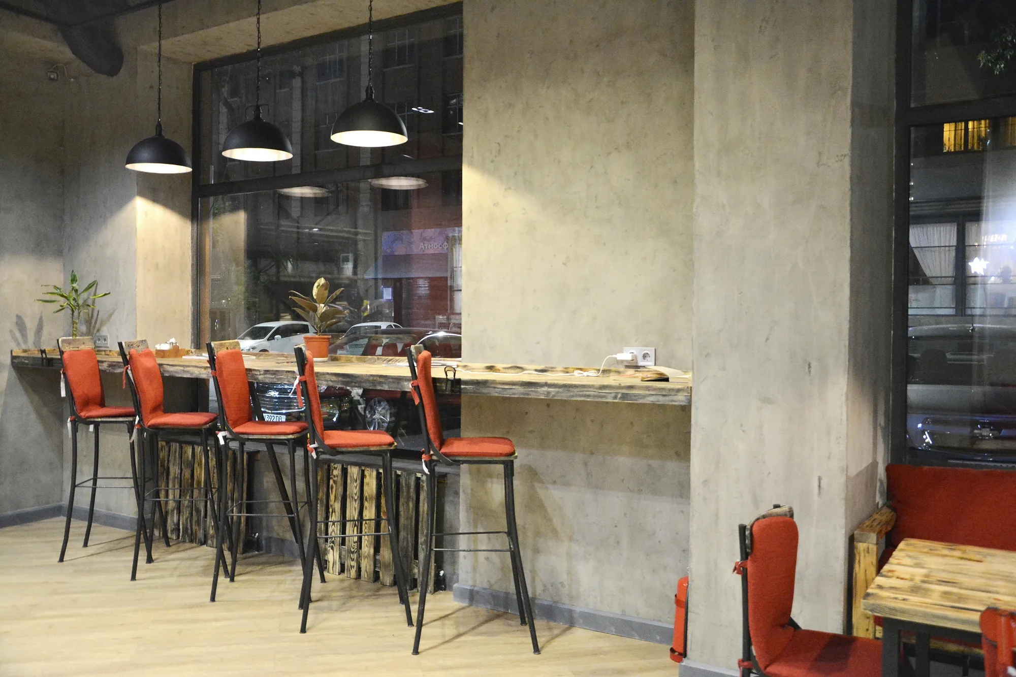 TIM'S Coffee & Roastery in Tashkent: a high counter with bar stools by the window — SAD studio
