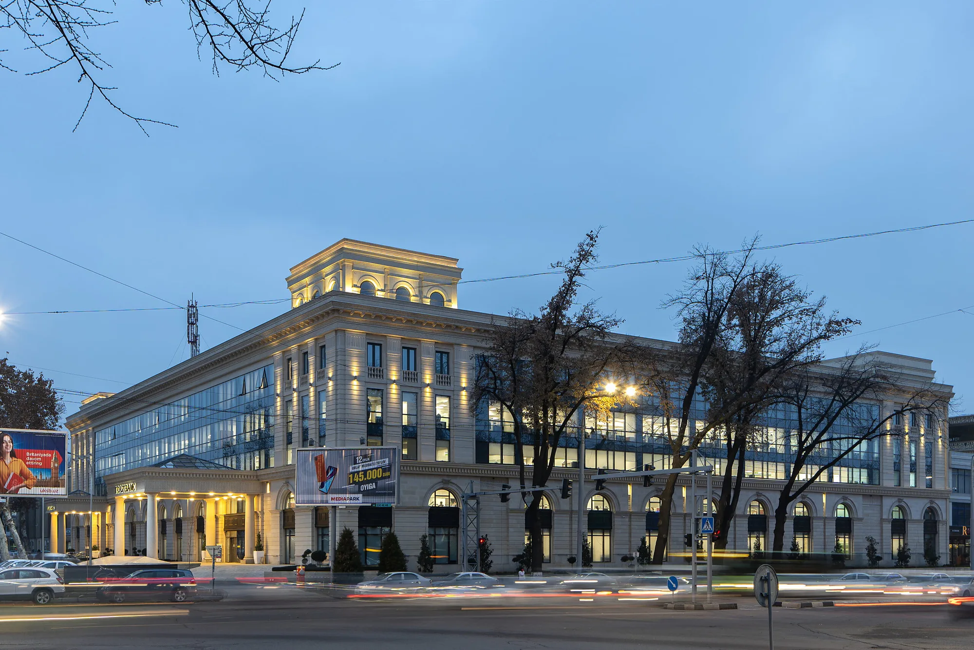 The Trast Bank building in central Tashkent after reconstruction: the classical arcaded facade lit at dusk — SAD studio
