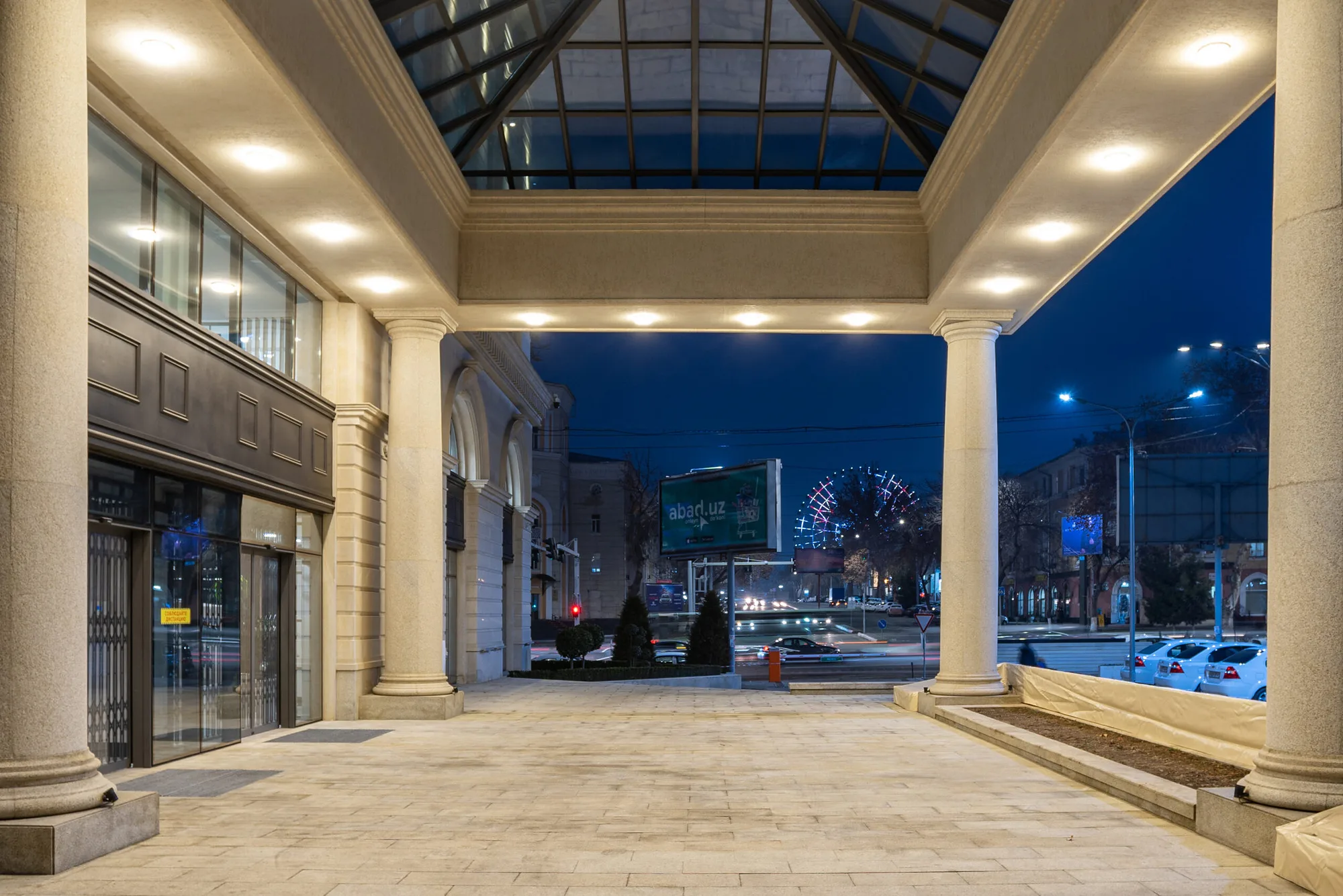 The Trast Bank arcade in Tashkent at night: the glazed vault over the passage and the view to the avenue — SAD studio