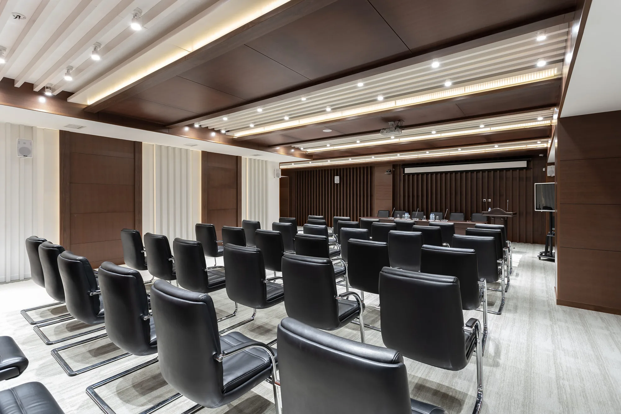 The Trast Bank conference hall in Tashkent: rows of seats, timber panelling and a lit ceiling — SAD studio